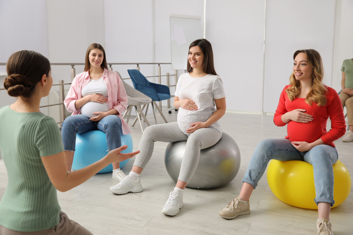 Group of Pregnant Women with Trainer at Courses for Expectant Mo